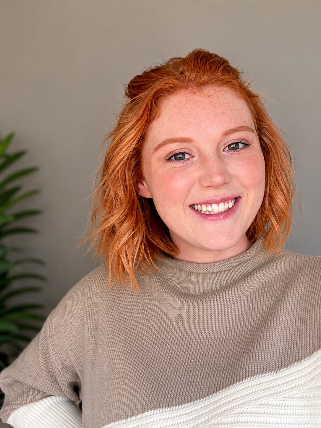 Rune Baggett, a person with medium-length red hair and light skin smiling